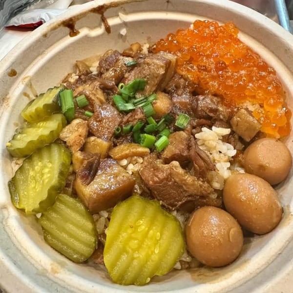 Taiwanese braised pork belly rice bowl with pickles, marinated eggs, and orange fish roe.
